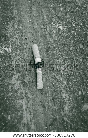 Cigarette butts on side street dirty floor,Black and white tone