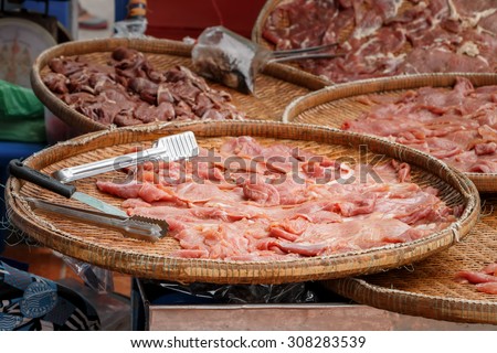 Fresh chicken meat sliced on the basket for sell in the market, selective focus
