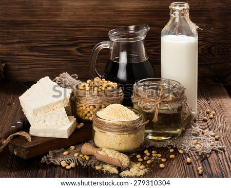 Soy products (soy flour, tofu, soy milk, soy sauce) on a wooden background. rustic style