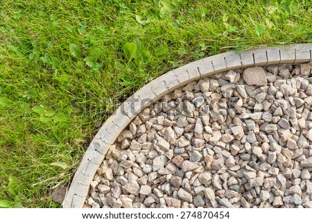 Corner of garden path - construction detail showing gravel, edging strip & lawn