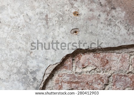 Brick wall with plaster partially removed. Suitable as background