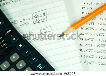 A math book with a calculator and math paper