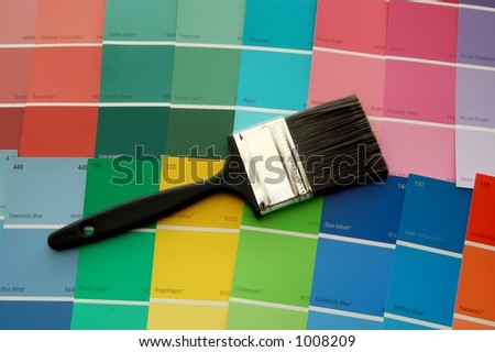 A paint brush on paint color cards