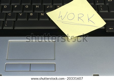 Post-it memo with word work on laptop keyboard