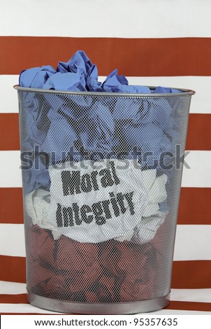 Integrity is a Core Value. A mesh trash can full of red, white and blue wads of paper with the words Moral integrity on one piece of wadded paper against red and white striped background.