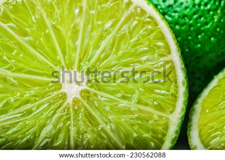 Sliced lime with whole lime on the background