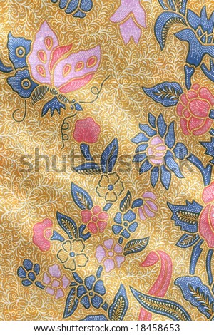 stock photo : Yellow batik sarong with floral motif and a butterfly