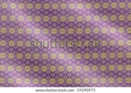 Intricate pattern of a traditional purple and gold Songket cloth
