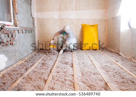 Work composed of cellulose insulation in the floor, floor heating insulation , warm house, eco-friendly insulation, insulation paper, a builder at work