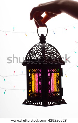 Young Muslim kid hand holding Ramadan lantern