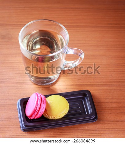 Chicken Hen Eggs in cup whit cookies and glass of drinking water on Wood table.vintage look.Chicken Hen Eggs in cup whit cookies and glass of drinking water on Wood table.vintage look.