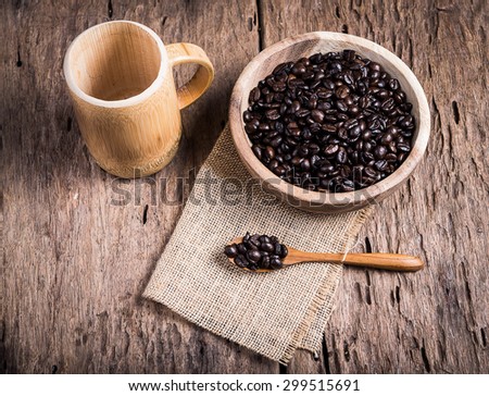Soft focus image of coffee beans and coffee cups set on wooden background.Vintage style.(soft focus)