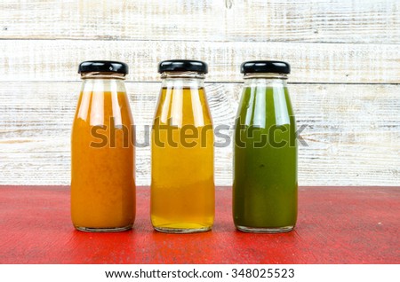 Juice bottle on vintage wooden background