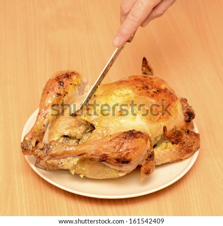 cut roast chicken on plate