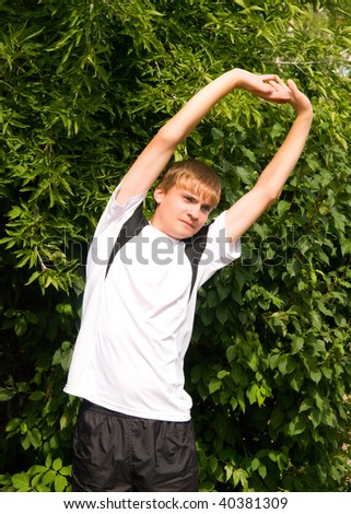 young man does warm-up in the open air
