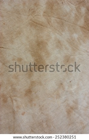 Old white fabric with a dirty stain on the surface.