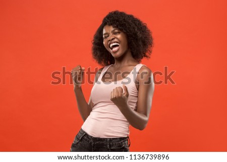 I won. Winning success happy woman celebrating being a winner. Dynamic image of caucasian female model on red studio background. Victory, delight concept. Human facial emotions concept. Trendy colors