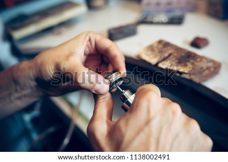 Different goldsmiths tools on the jewelry workplace. Jeweler at work in jewelry. Desktop for craft jewelry making with professional tools. Close up view of tools.