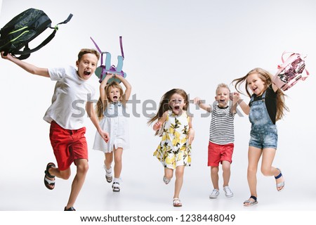Happiness group of cute and adorable teen children or students are back to school. over white studio background. The friendship, education, childhood, kids fashion concept