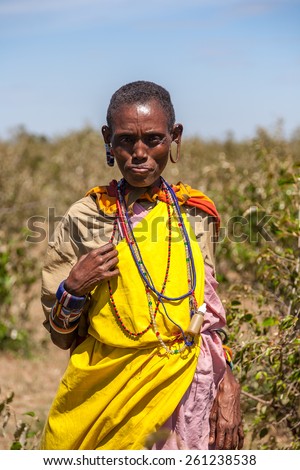Masai Mara, Kenya, Africa - February 12, 2010 : Masai woman in traditional clothes, review of daily life of local people, near to Masai Mara National Park Reserve, Feb 12, 2010,Kenya