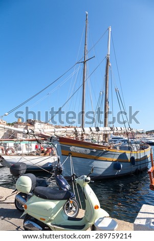 SAINT TROPEZ, FRANCE -  SEPTEMBER 16, 2008: View of Saint Tropez harbor with yachts and bikes on September 16, 2008, Saint Tropez. St. concept of modern modes of transport rich people