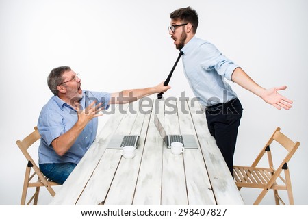 Business conflict. The two men expressing negativity while one man grabbing the necktie of her opponent on white background
