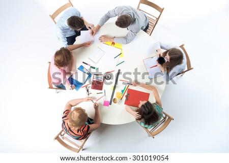 Top view of business team, sitting at a round table on white background. concept of successful teamwork