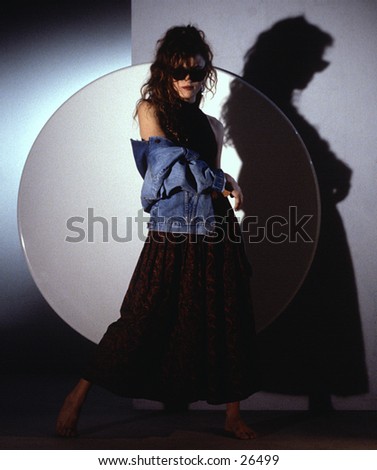 Woman pposing in front of circle in a studio