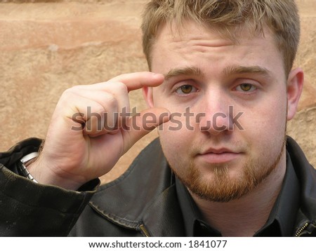 stock photo Teen closeup of face with fingers showing size of something