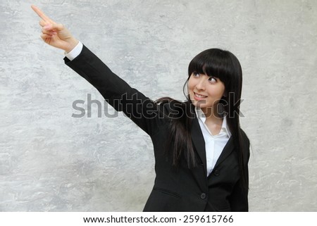 Business woman pointing at something with smile