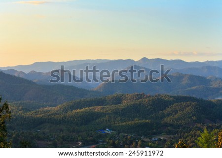 Winter landscape in Thailand in the evening. We can see the village and the mountains at 5:41 PM.