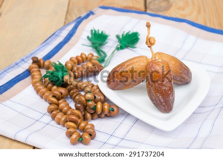 date palm on the cloth. Fasting is obligatory for adult Muslim in Ramadan. Muslim will breaking their fasting after sundown with a date palm or with water to  following the tradition.