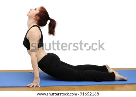 Woman in yoga posture called Upward-Facing Dog on a blue rug, isolated with clipping path.