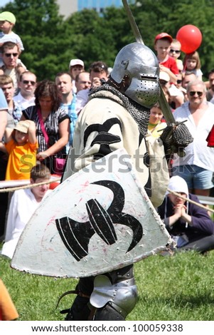 WARSAW, POLAND - JUNE 6: Struggle medieval knight during XV Knight Tournament on June 6, 2010 in Warsaw, Poland. Knight warms up before the duel.