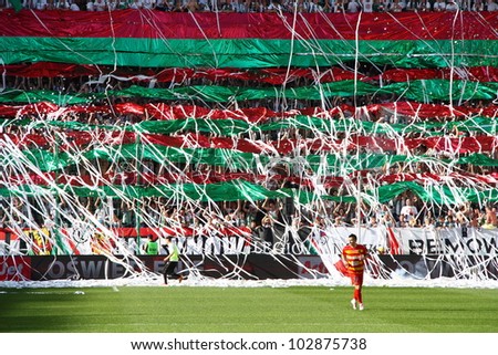 WARSAW, POLAND - APRIL 29: Streamers thrown by fans during a football match between Legia Warsaw vs Jagiellonia Bialystok on April 29, 2012 in Warsaw, Poland. Final results: 1:1