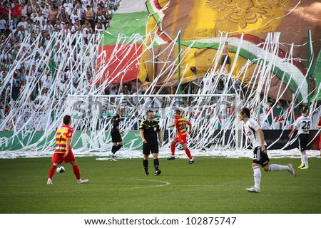 WARSAW, POLAND - APRIL 29: Streamers thrown by fans during a football match between Legia Warsaw vs Jagiellonia Bialystok on April 29, 2012 in Warsaw, Poland. Final results: 1:1