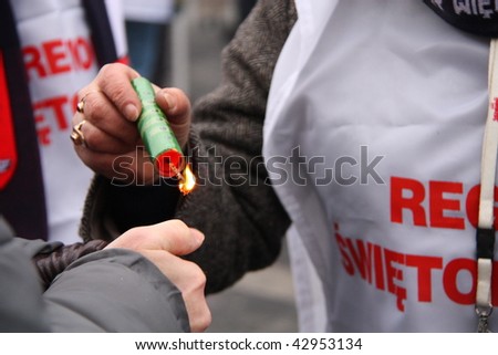 WARSAW, POLAND - DECEMBER 15: Closeup of Solidarity protesters with ready-to-use firecracker during anti government Solidarity demonstration on December 15, 2009 in Warsaw, Poland.