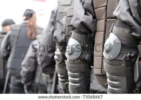 WARSAW, POLAND - MARCH 6: Police cordon protecting people taking part in Feminist demonstration to support women rights, on March 6, 2011 in Warsaw, Poland.