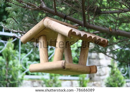 Wooden bird feeder. The success of a bird feeder in attracting birds 
