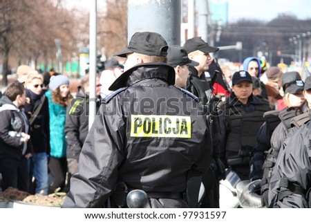 WARSAW, POLAND - MARCH 11: Police secures the Feminist demonstration to support women rights, on March 11, 2012 in Warsaw, Poland.