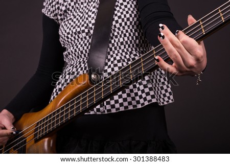 Punk Rock Girl Playing Bass Guitar Closeup