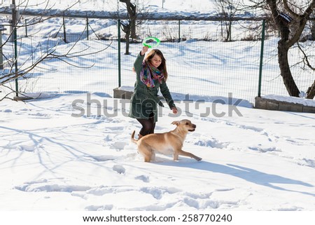 Model Jana playing with her dogs in winter.