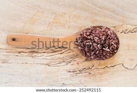 Healthy cooked rice on Wood Ladle. Wood splat Background
