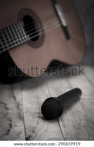 Still life whit Microphone and classic guitar waiting on wooden floor, vintage style