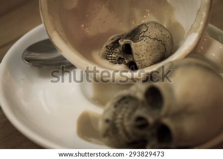 Still Life Skull in Coffee Cup , Danger furtively in Coffee concept,Coffee Addiction ,vintage style color