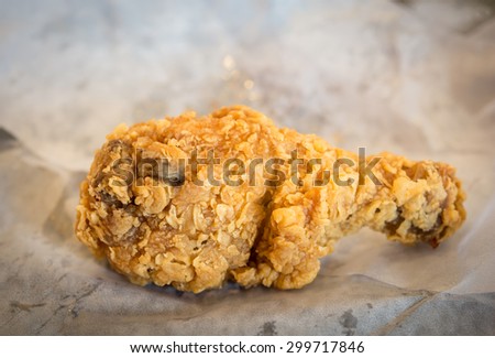 Close up Chicken drumstick fried on Food tissue paper