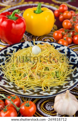 salad with fresh vegetables and chicken on plate in the oriental style