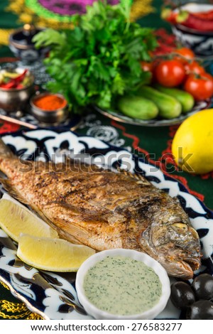 Juicy Dorado fish cooked over charcoal on a special recipe