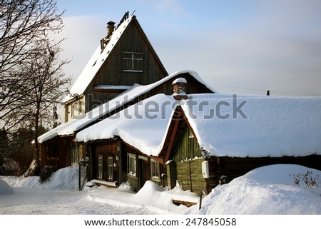 snow-covered wooden houses in winter village