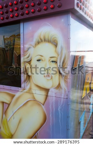 UK, BLACKPOOL, NOVEMBER 2ND - A pouting woman painted onto the side of a pay booth for a fair ground ride on South Pier, Blackpool -- taken on the 2nd November 2014.